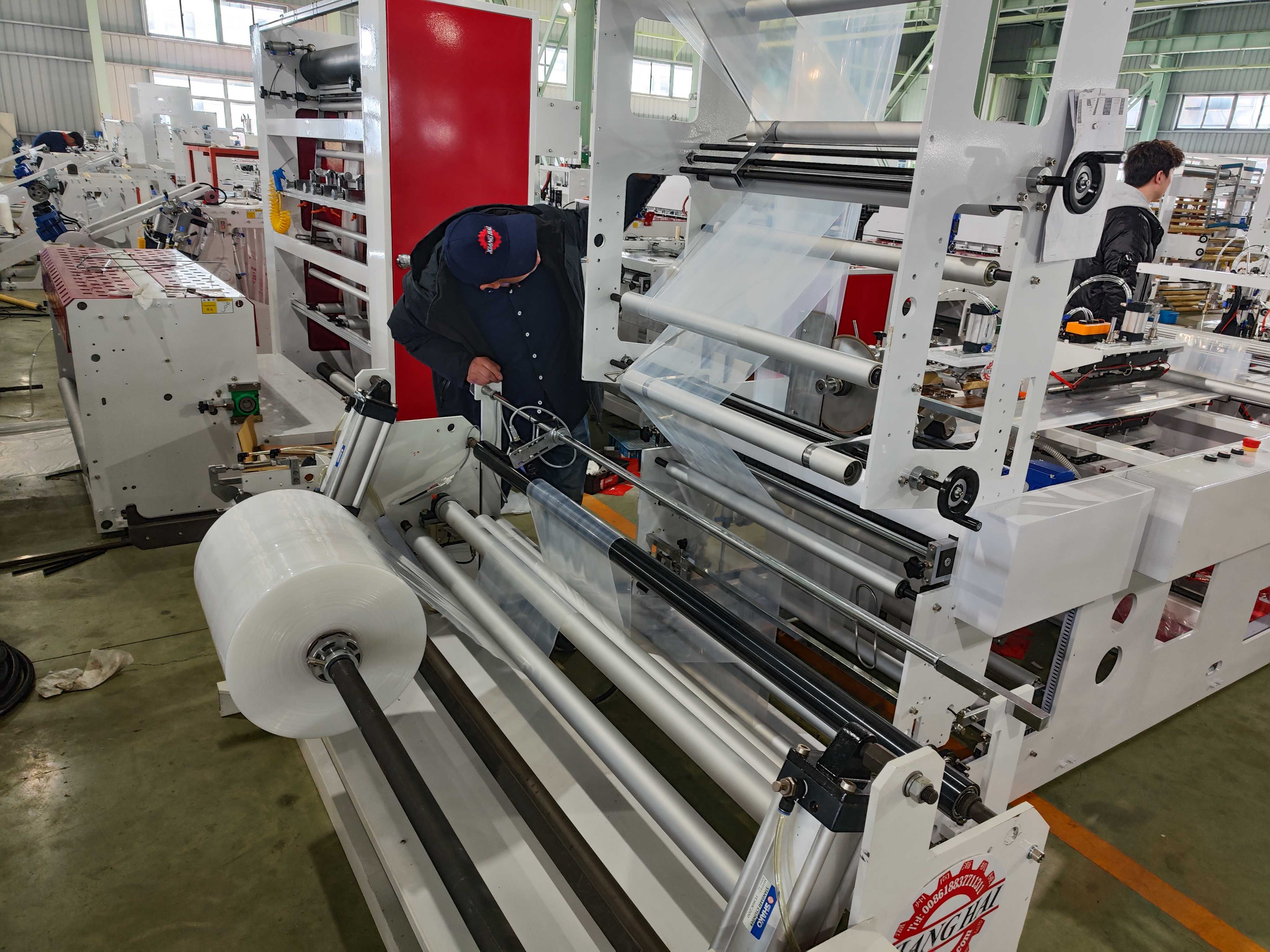 Our engineers are debugging the machine - Patch soft handle bag making machine.